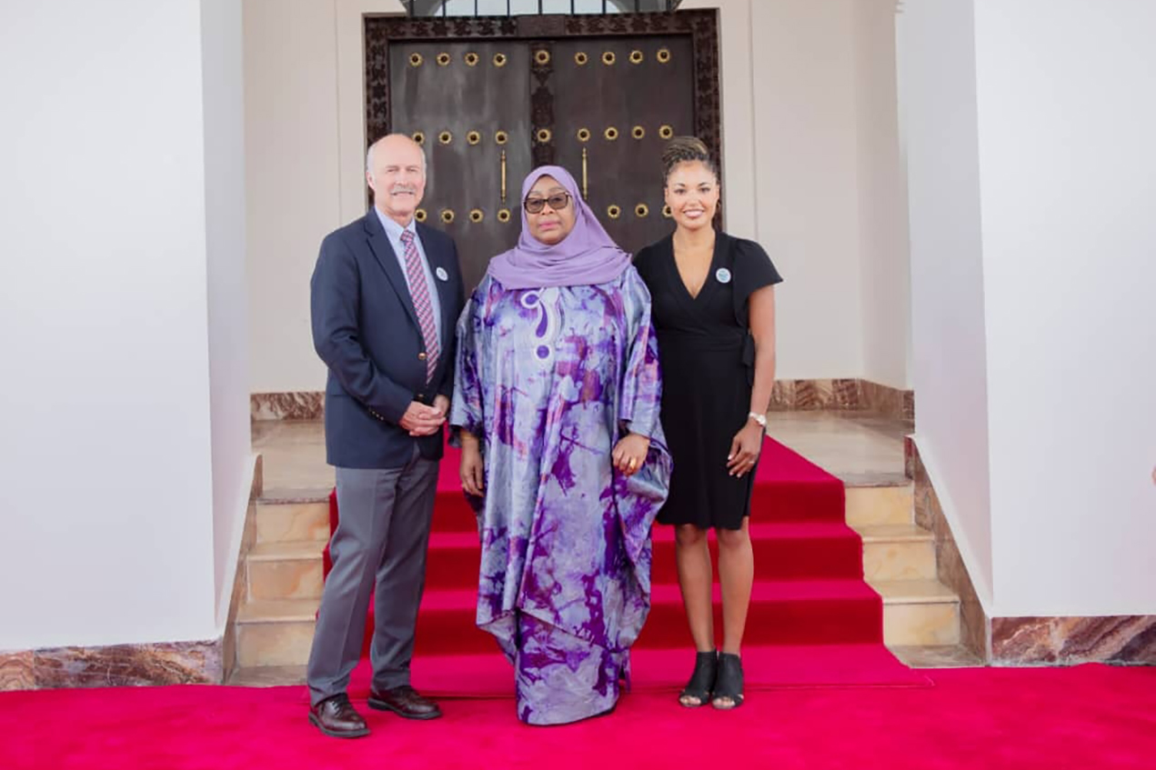 Paul Gilbert, MD (left), and Aneesah Smith, MD (right), with Samia Suluhu Hassan, president of Tanzania.