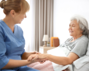 A nurse visits an older woman for at-home cancer treatment.