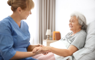 A nurse visits an older woman for at-home cancer treatment.