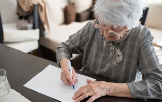 An older white woman takes a test for Alzheimer's and related dementia disorders.