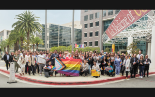 Keck Pride and fellow supporters prepare to raise the Pride flag outside Keck Hospital of USC