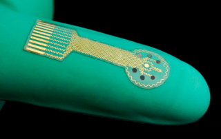 A green finger bandage bears a visible microchip