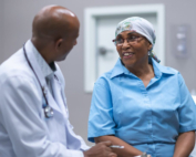 An African American breast cancer patient talks with her doctor