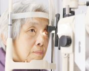 An older woman has her eyes checked for macular degeneration