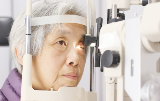 An older woman has her eyes checked for macular degeneration