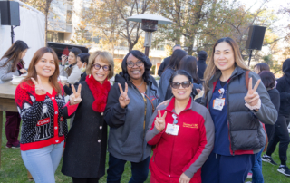 USC President Carol L. Folt with members of the Health Sciences Campus staff at the all-staff holiday reception.