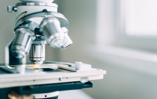 A microscope stands in a lab for pharmaceutical research