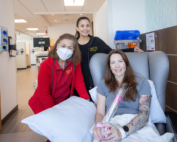 From left to right: Susana Victoria, RN, and Pamela Ann French, RN, present Keck Medicine Infusion patient and mother Jennifer Nunnery with a Mother's Day rose.