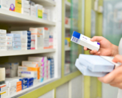 A pharmacist at risk of pharmacy closure gathers medication not covered under Medicare Part D