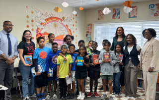 Dustin Baker, Michelle Sullivan, PT, DPT, and Shannon Bradley bring books to students of Pasadena Rosebud Academy on behalf of the Keck Medicine community