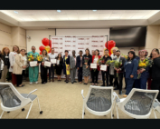 Annette Sy, DNP, RN, NE-BC, Ceonne Houston, DNP, RN, CSSBB, NEA-BC, CPHQ, and Awa Jones, RN, BSN, MSHCM, stand amidst the 2025 Nurses Week award recipients and Keck Medical Center nursing leadership