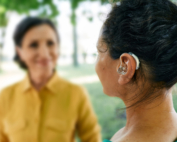 A woman with an assistive hearing device enjoys an active social life