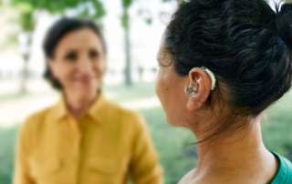 A woman with an assistive hearing device enjoys an active social life